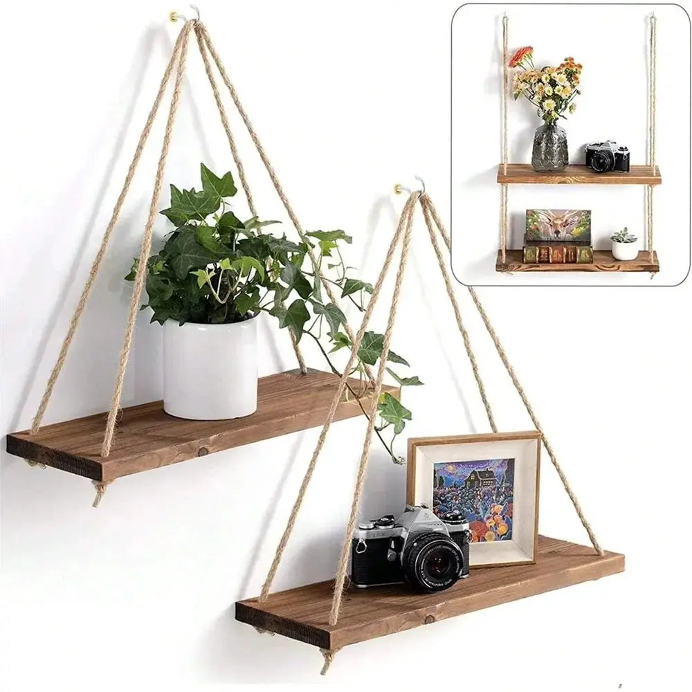 Two-tier wood hanging shelf set on hemp ropes with plant pot on top shelf and camera and framed photo on bottom.