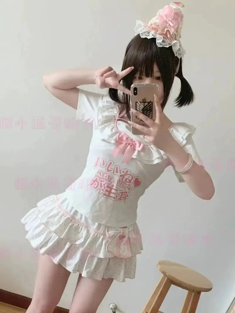 White Harajuku Lolita mini skirt with pink bow accents and layered ruffles