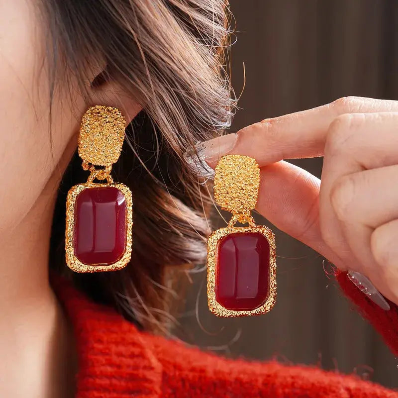 Women's vintage red resin geometric oval earrings with gold textured frames, pair