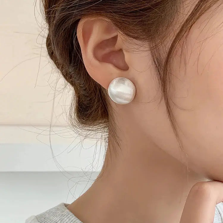 Round brushed metal stud earring in frosted silver finish