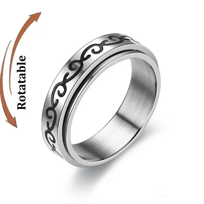 Fidget spinner ring in stainless steel with rotatable black scrollwork band; knuckle ring by Simples Market
