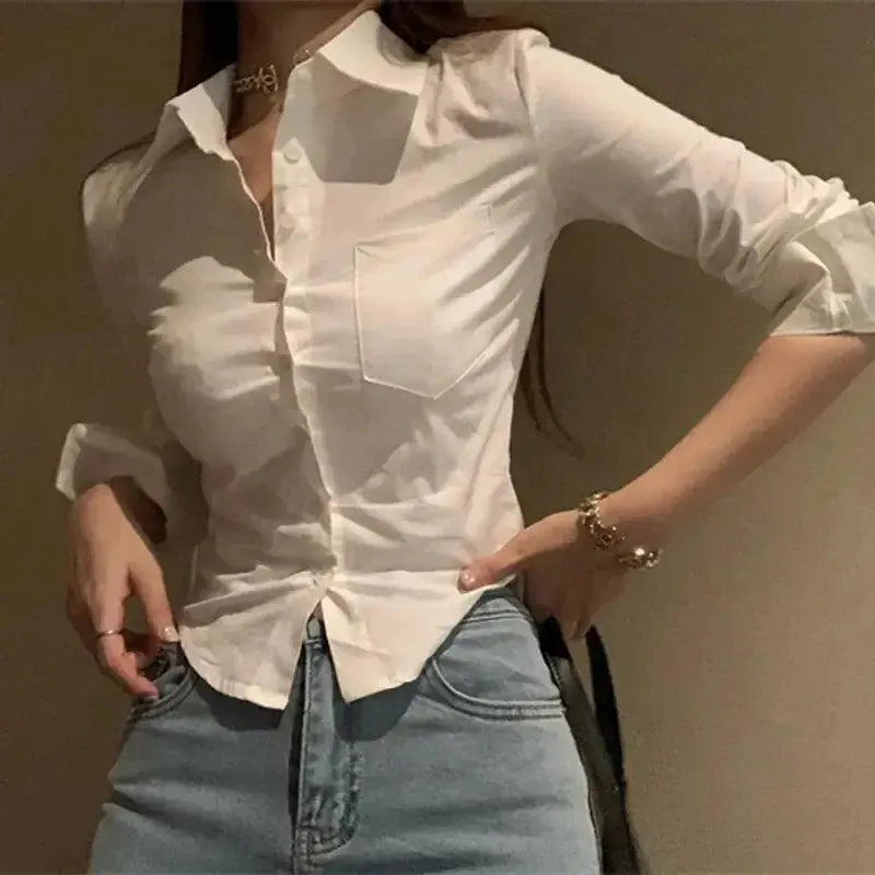White button-down blouse with chest pocket and rolled sleeves