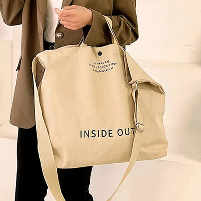 Unisex beige canvas cross-body bag with long strap and INSIDE OUT print