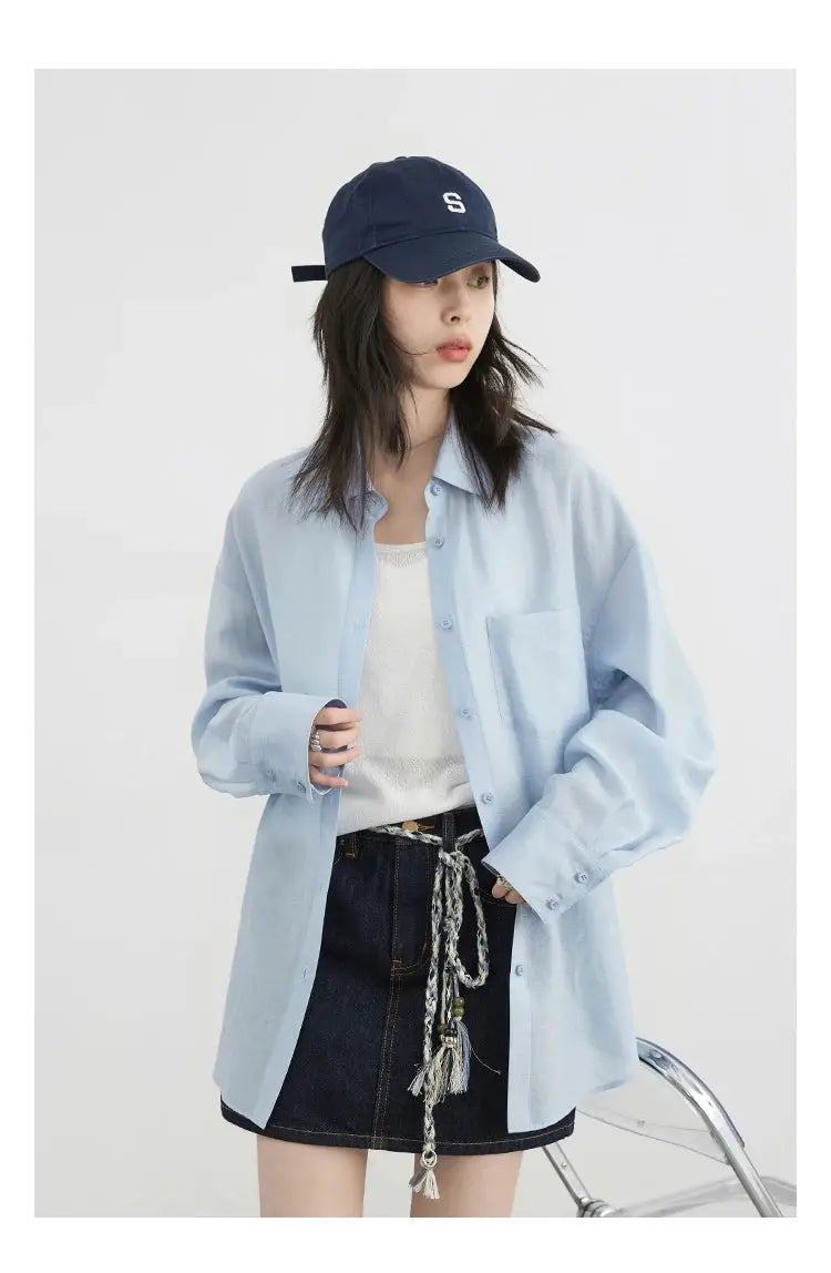 CHIC VEN women's light-blue long-sleeve shirt over white top with dark denim mini skirt and striped belt, navy cap
