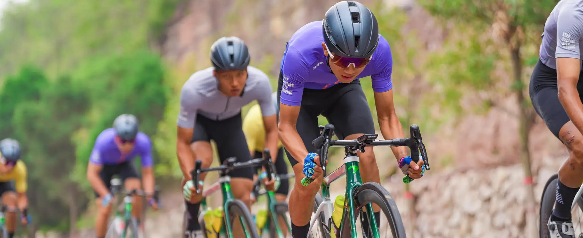 DAREVIE women's purple short-sleeve cycling jersey worn by cyclists in a group road ride