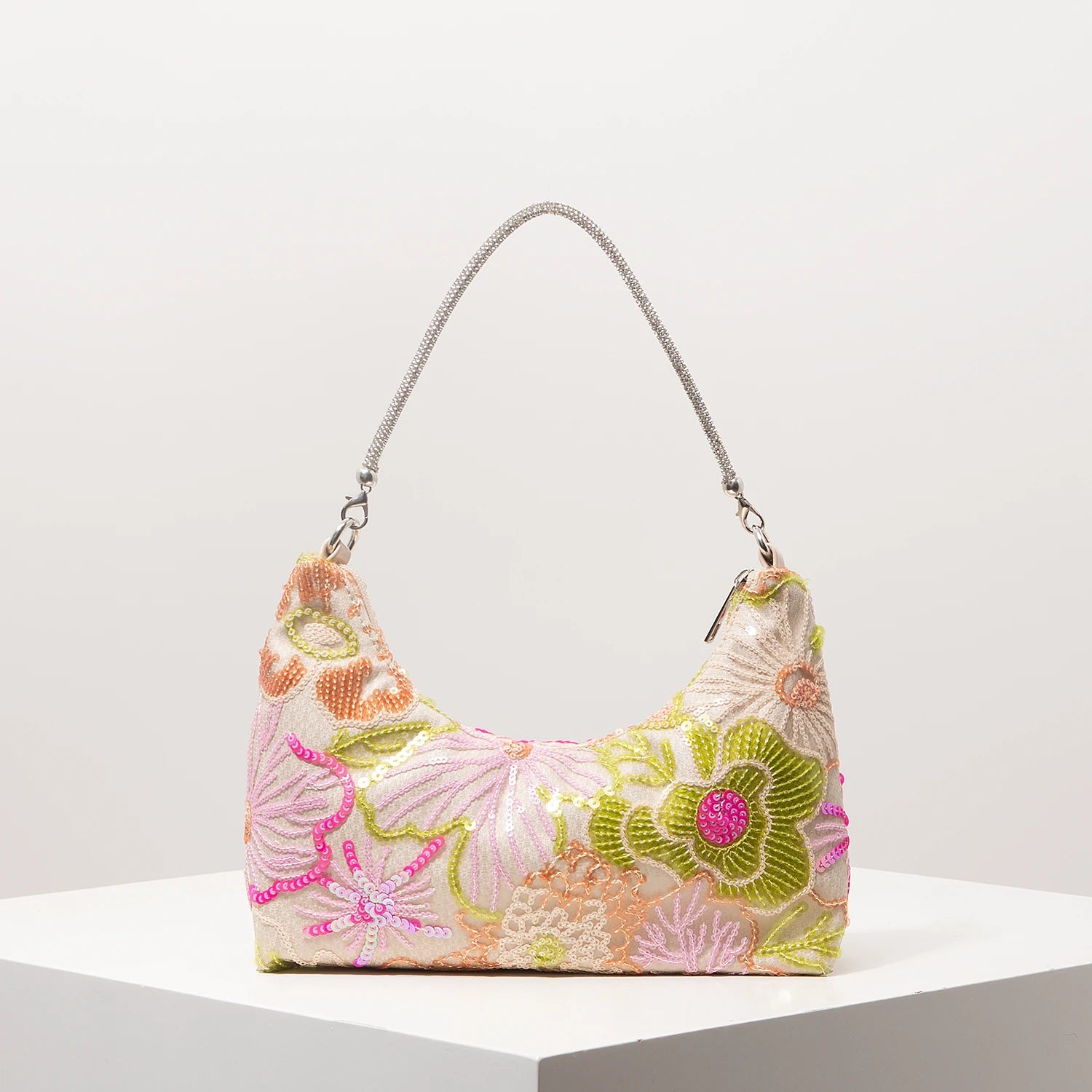 Shoulder bag with pastel pink fabric, embroidered floral pattern and sequin accents, silver chain strap