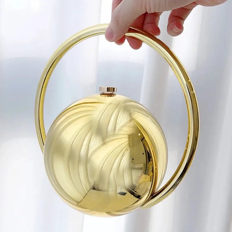 Gold acrylic evening clutch with ball-handle circular ring