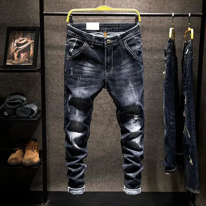Men's Simples Market distressed straight jeans, blue-black cotton denim with ripped details and rolled cuffs.