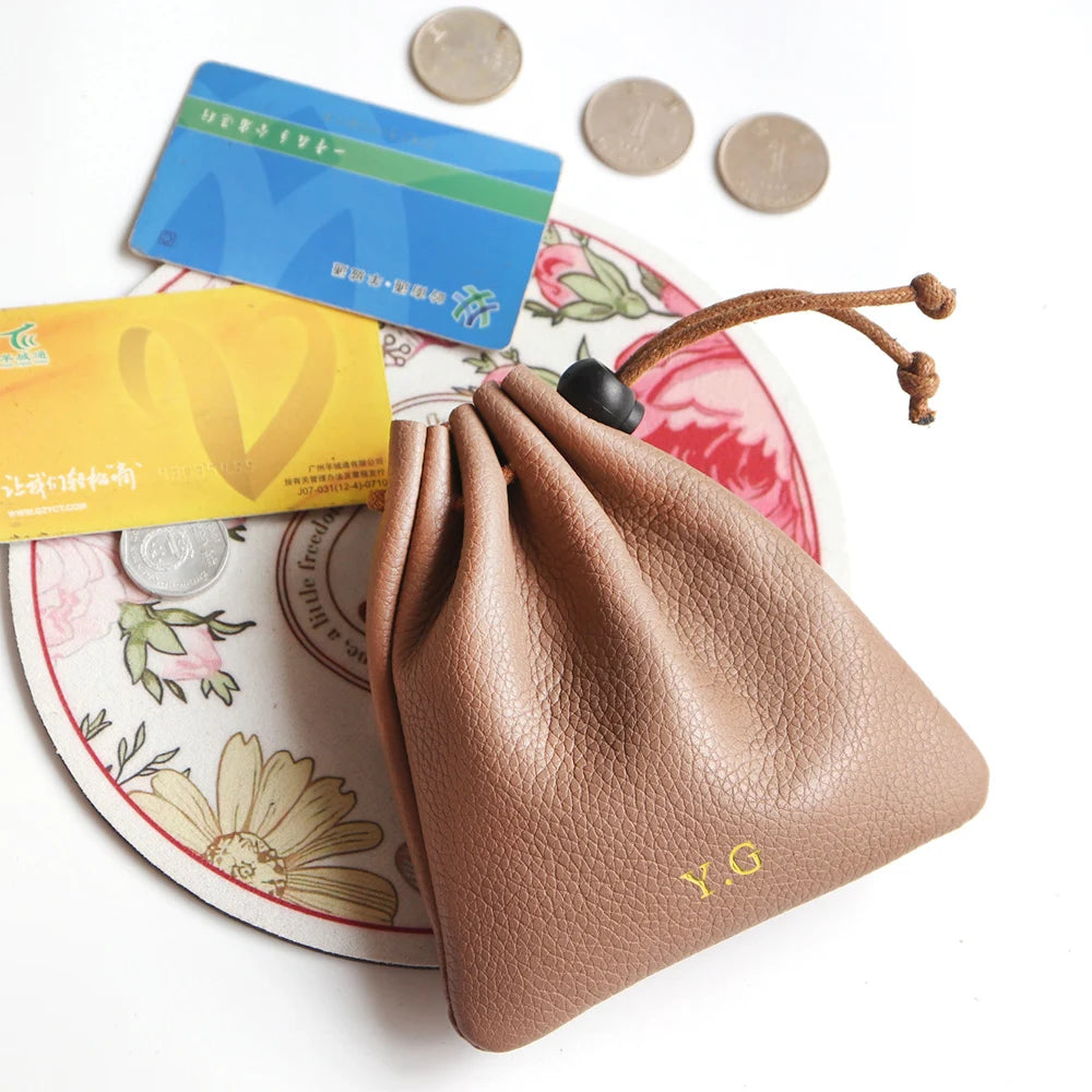 Brown genuine leather card holder with Y.G monogram, drawstring pouch; 3 visible cards and 3 coins