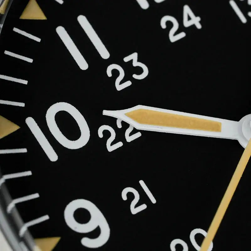 Militado ML07 quartz watch dial close-up with black dial, white numerals, and luminous gold-tone hands