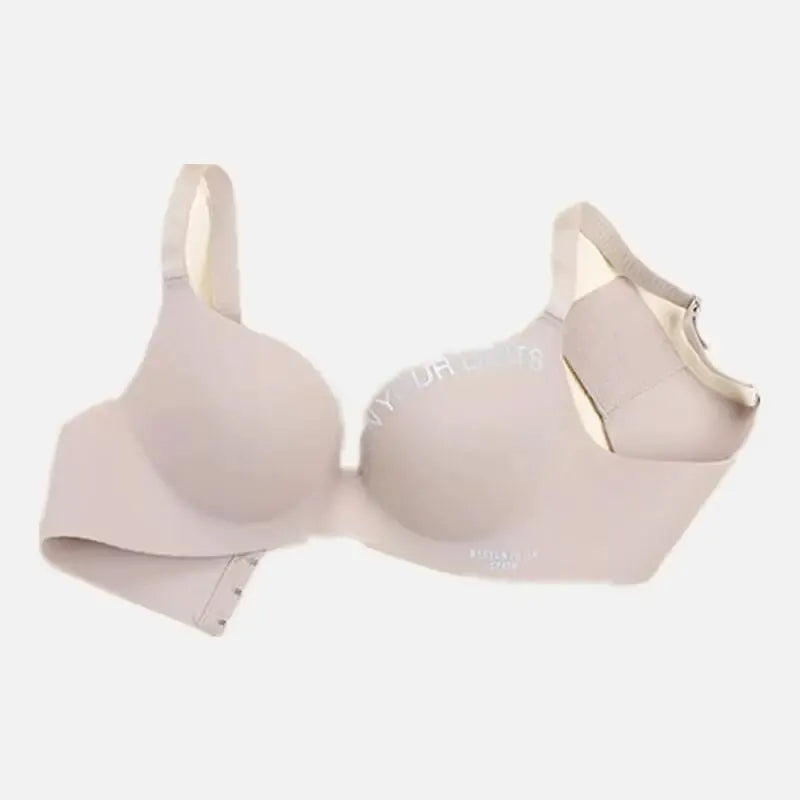 Nude seamless padded bra with printed lettering on cups, adjustable straps, back closure