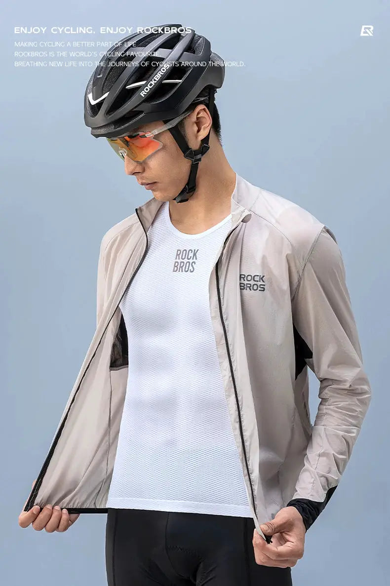 ROCKBROS bike vest with white breathable mesh undershirt and beige lightweight windbreaker, worn with a cycling helmet