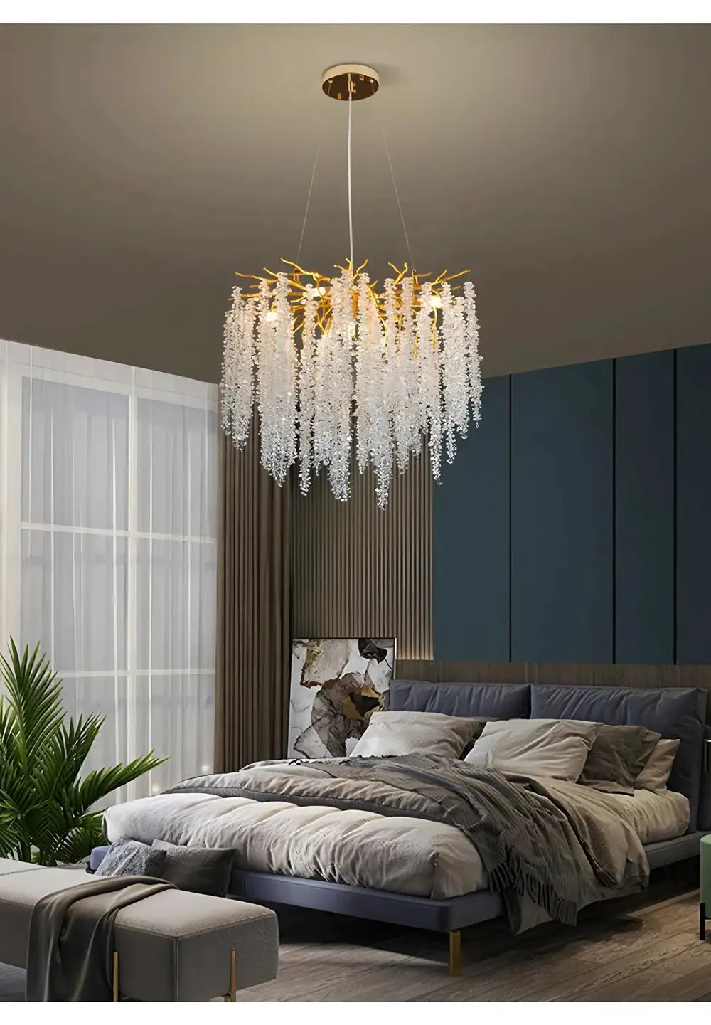 Modern crystal chandelier with gold-tone branches and dangling crystal droplets in a bedroom.