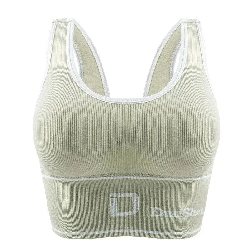 Women's seamless ribbed sports bra top in beige with white trim; wireless full-coverage bralette.