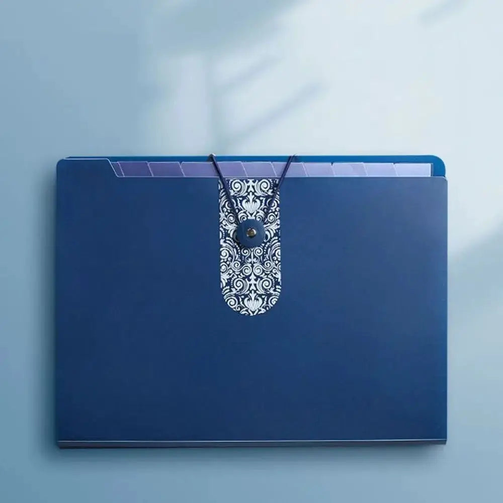 Blue A4 organ file folder with decorative patterned strap closure and interior divider tabs