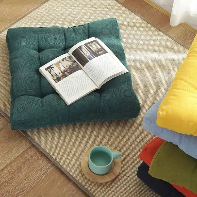 Floor pillow by Simples Market, teal green square tufted cushion for floor seating, set of 5 colorful cushions nearby