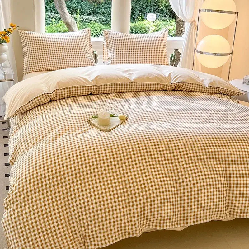Beige gingham duvet cover set with two matching pillowcases on bed