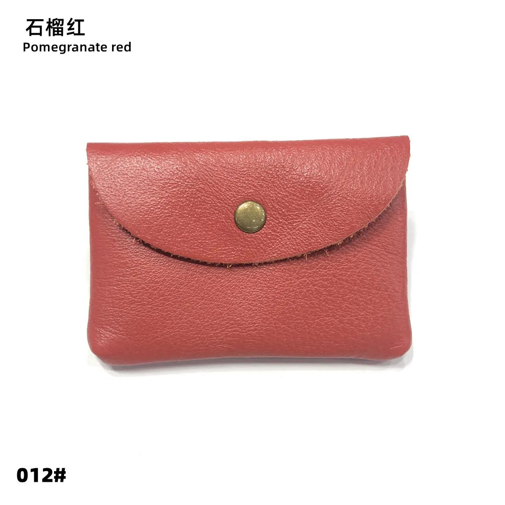 Card holder by Simples Market in pomegranate red, genuine leather with envelope-style flap and brass snap.