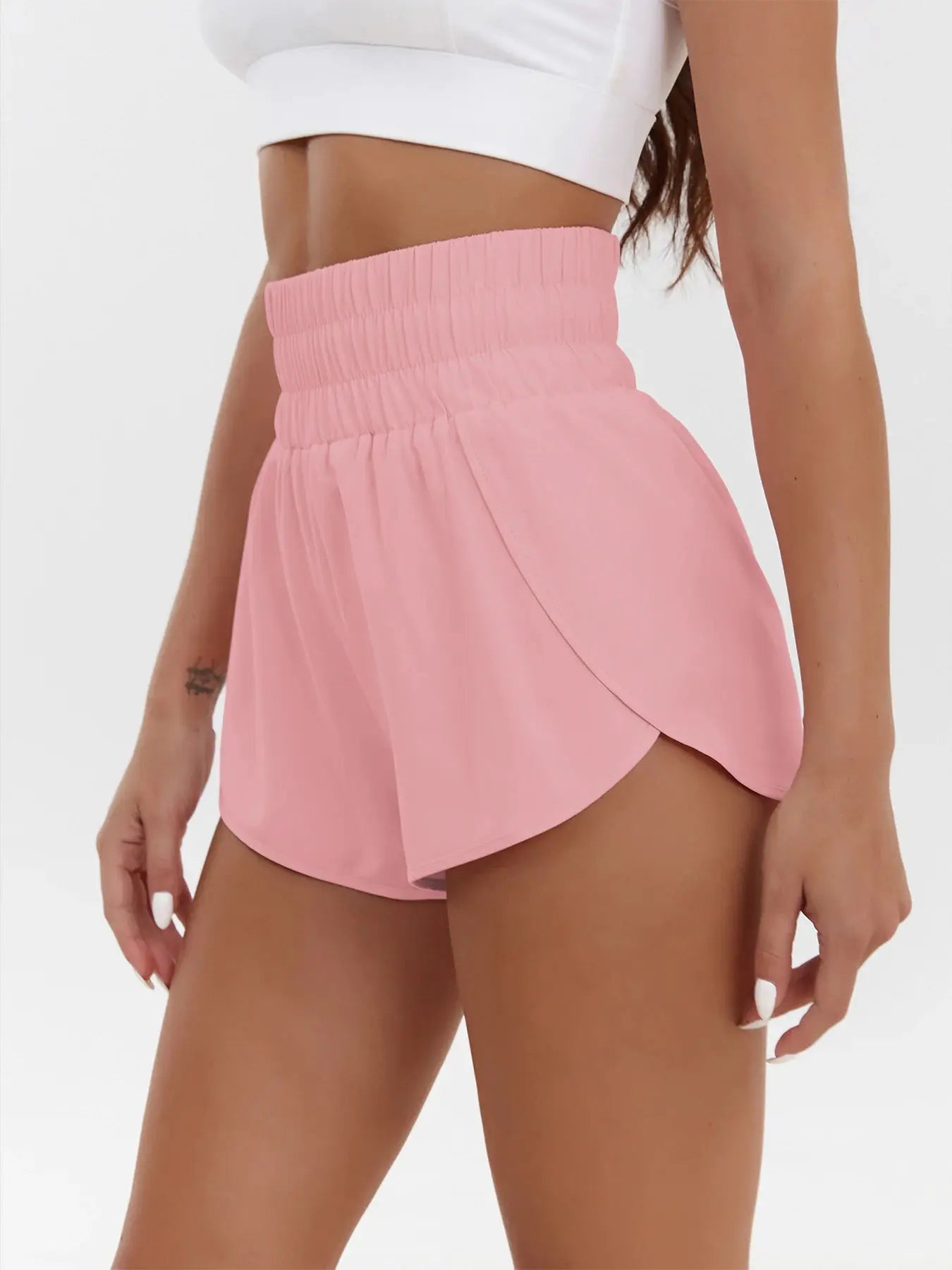Women's pink high-waist athletic shorts with elastic waistband and curved hem by Simples Market.