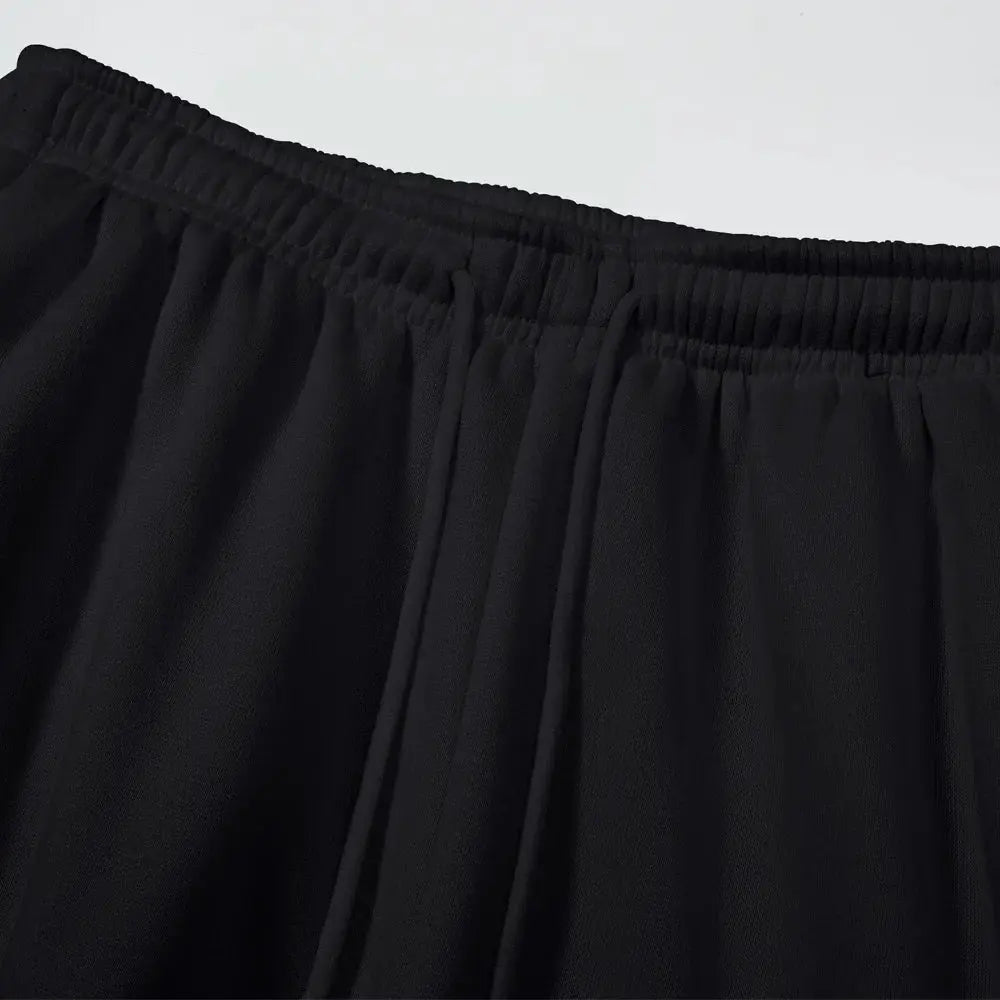 Men's black cargo sweatpants with elastic waistband, close-up of soft fabric