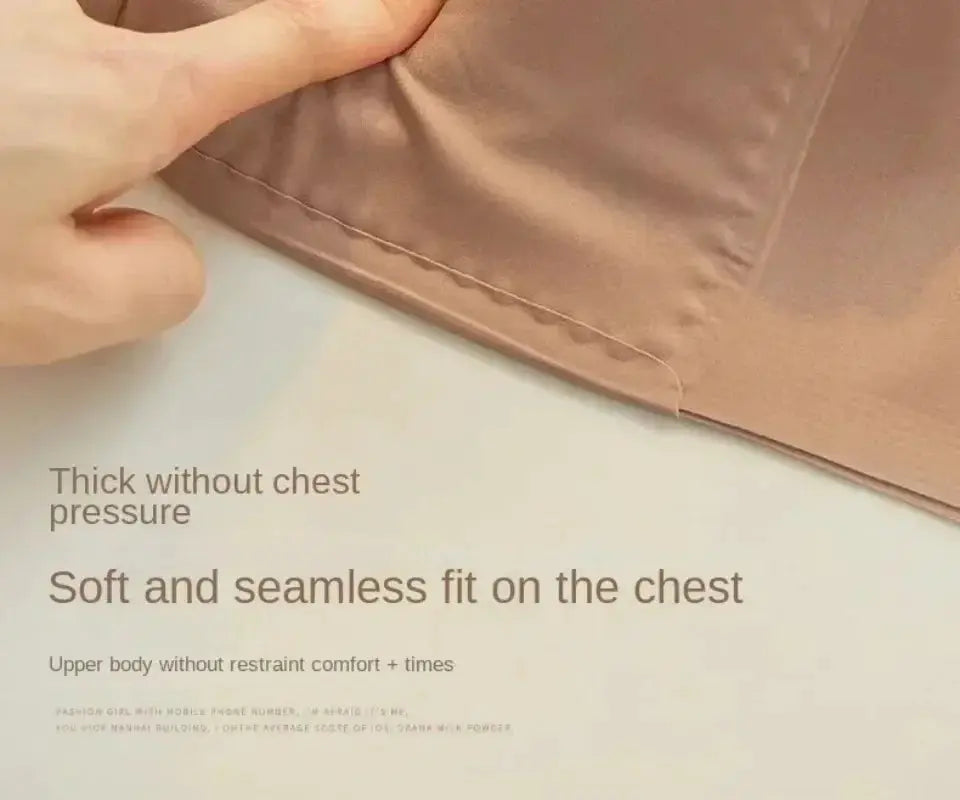 Bra by Simples Market; beige fabric close-up with stitched edge.