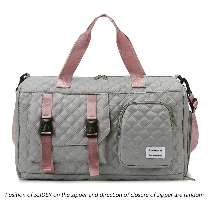 Duffle bag: gray quilted nylon with pink handles, front buckle pockets, side zip pocket, and ZUOMANNI tag.