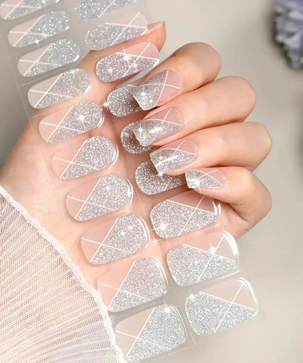 Gel nail wraps by Simples Market; silver glitter triangle designs on nude pink base, set.