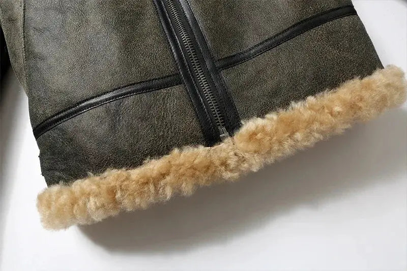 Men's leather fur jacket with beige shearling trim at hem and front zipper.