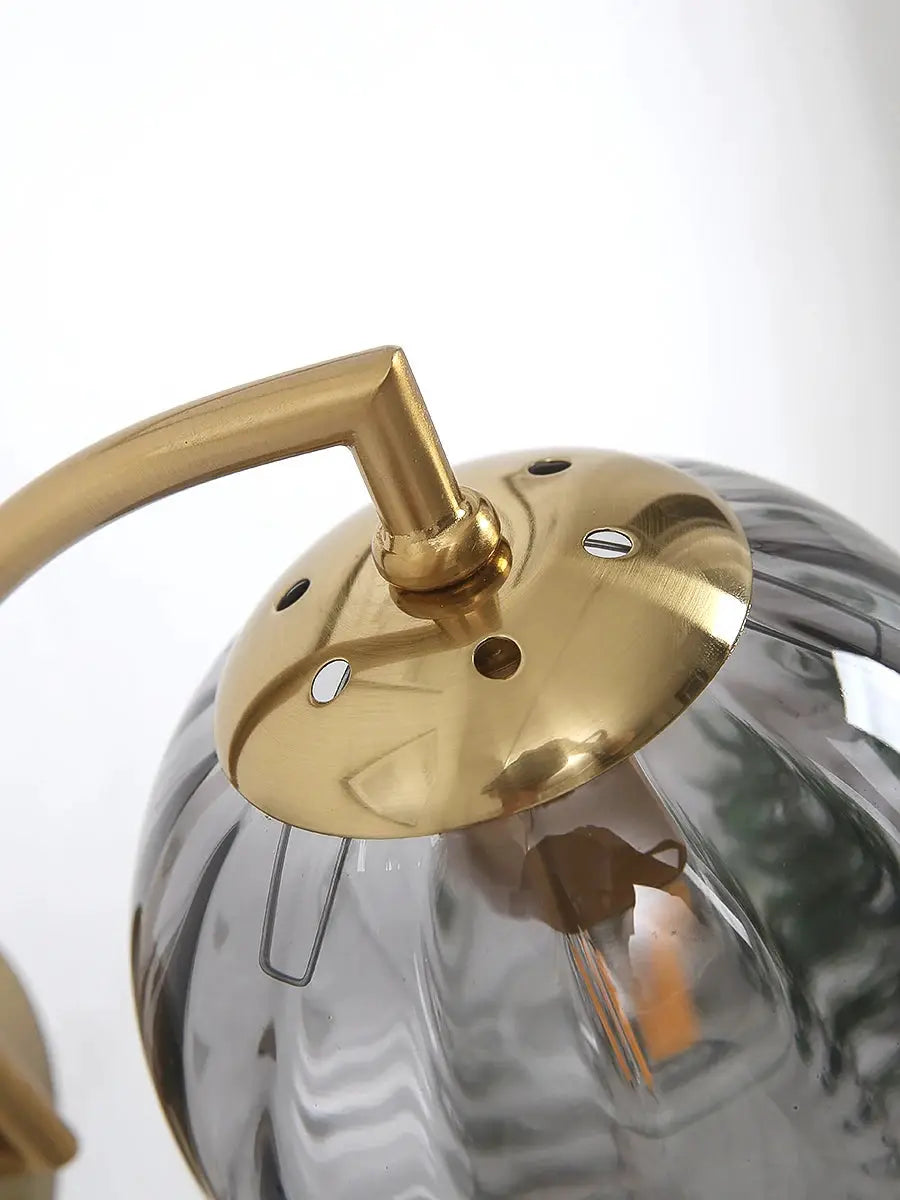 Modern LED wall lamp by Simples Market with brass mount and glass globe shade