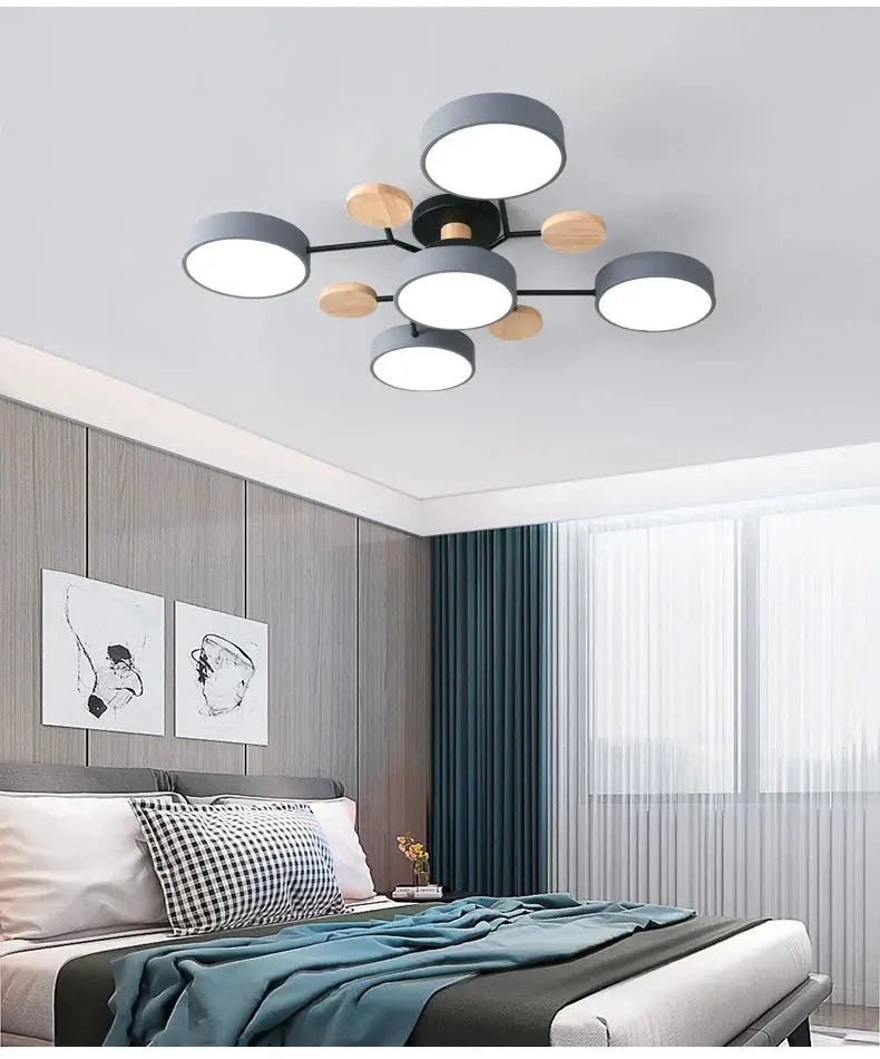 Modern LED ceiling chandelier by Simples Market; gray circular lights with natural wood accents in a Nordic bedroom setup.