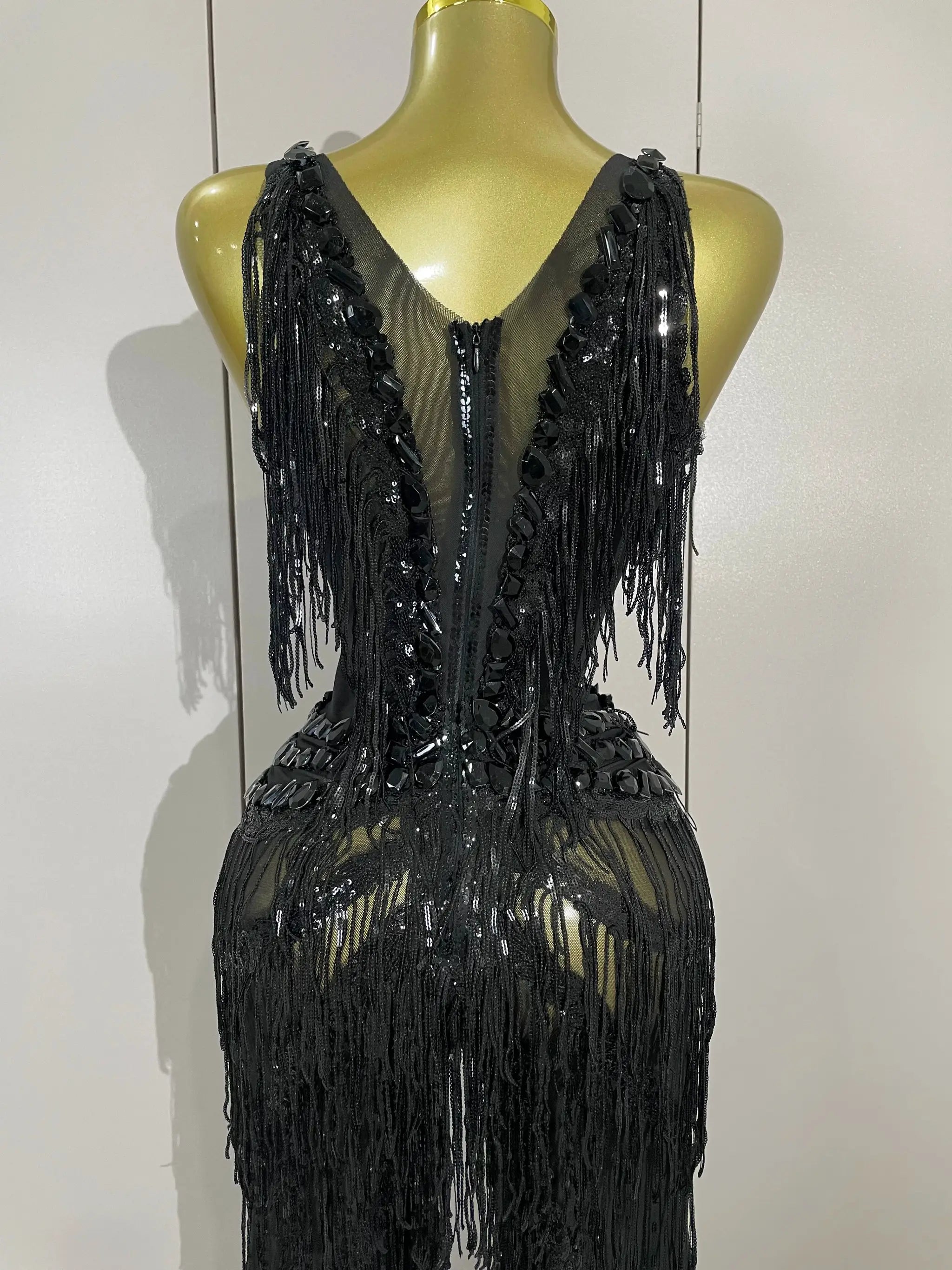 Black rhinestone sequined fringe jumpsuit on mannequin, back view with long fringe strands