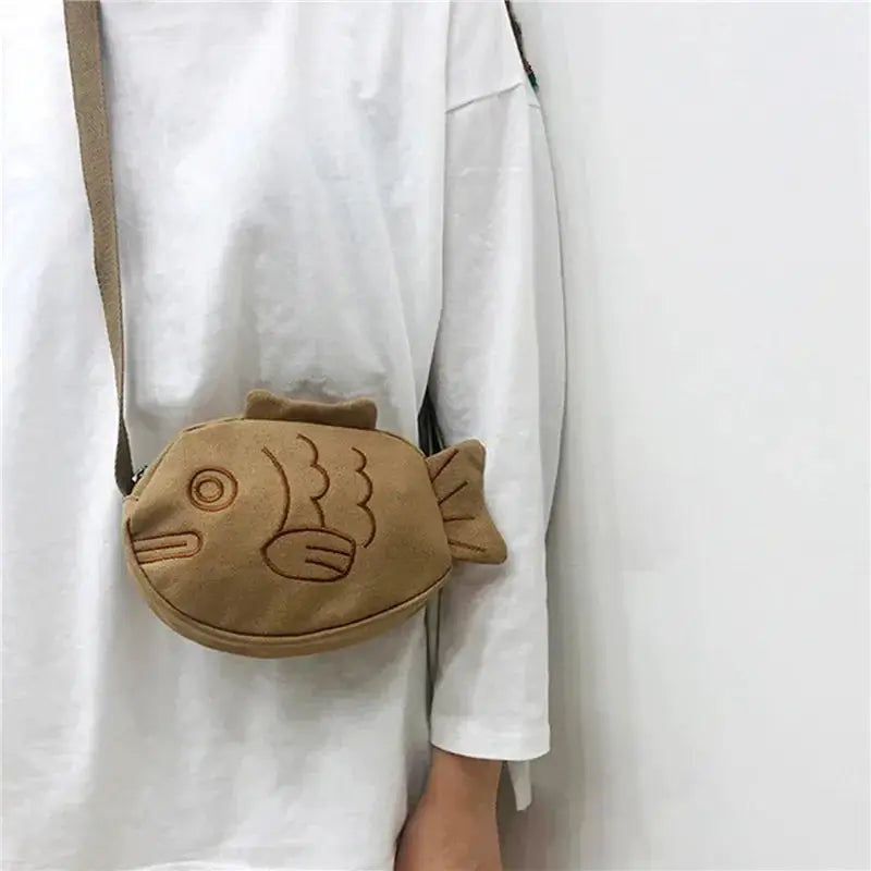 Fish-shaped tan canvas messenger bag with embroidery; compact crossbody purse with zipper
