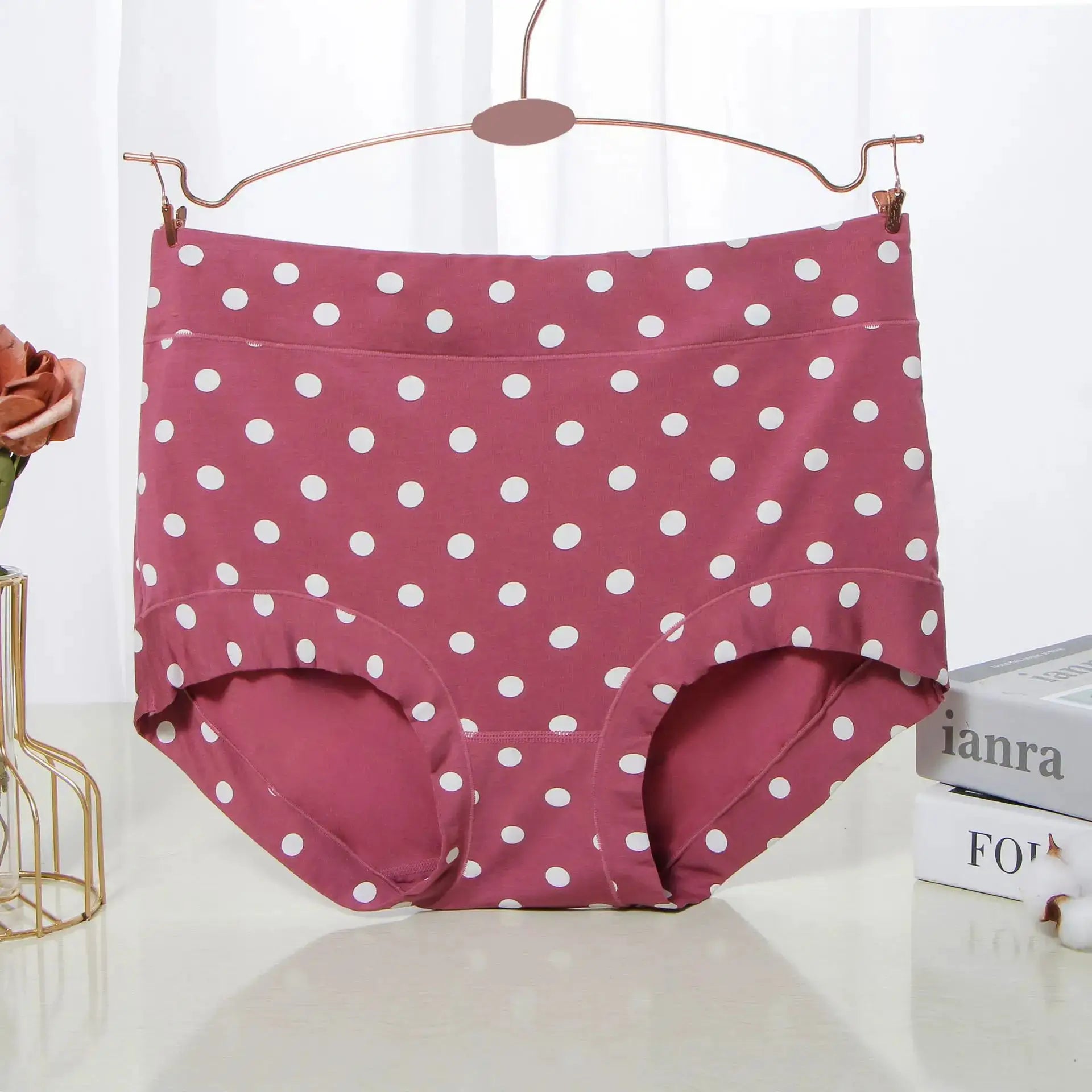 Polka-dot pink high-waist panties on a hanger; large size women's briefs