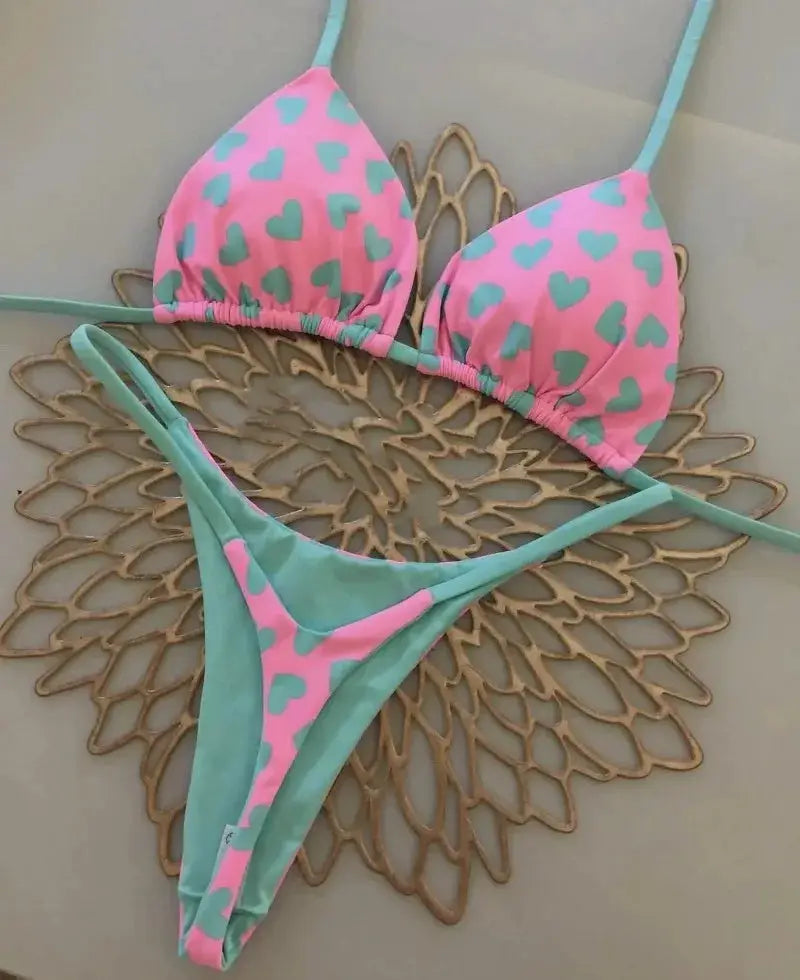 Simples Market 2-piece bikini set: pink heart-print halter top with turquoise straps, teal thong bottom.