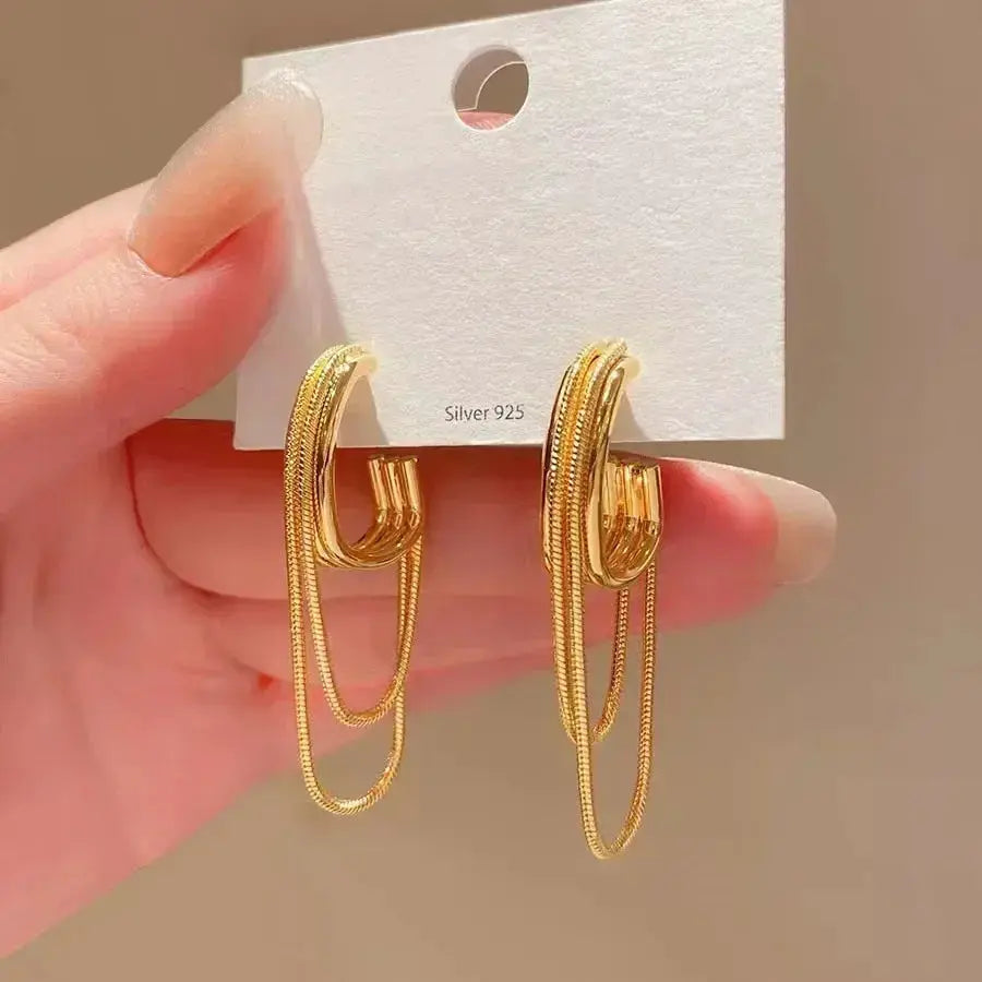 Pair of gold-tone ocean-style shell texture hoop earrings with chain accents