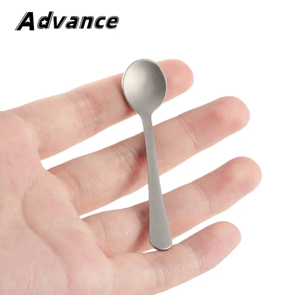 Mini titanium alloy dessert spoon by Simples Market, a small camping coffee mixing spoon in metallic silver.