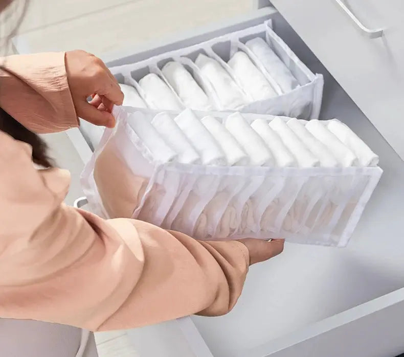 Organizer panties and socks storage box in white fabric with multiple compartments inside a drawer, neatly organized