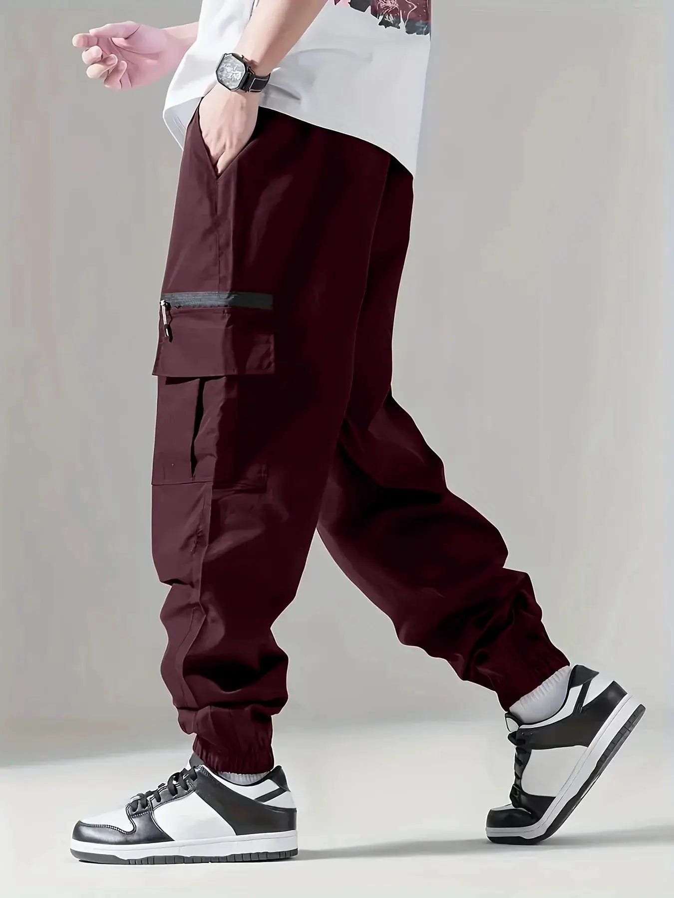 Men's cargo pants burgundy with multiple pockets, zip pocket, and elastic cuffs