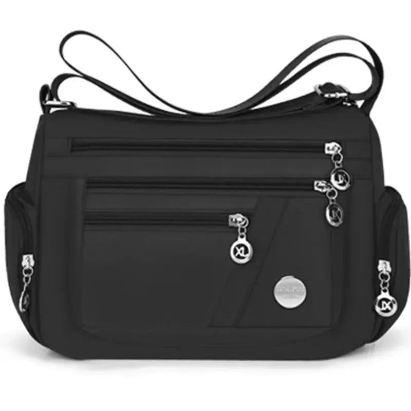 Simples Market black nylon crossbody bag with multiple zip pockets, adjustable shoulder strap, and multi-compartment travel design