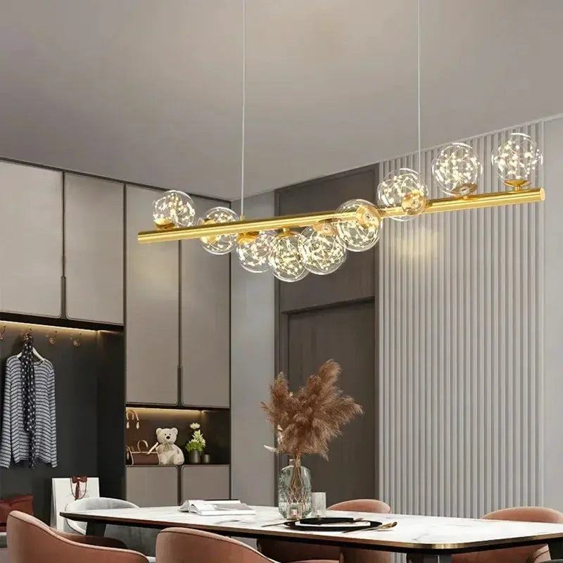 Nordic ceiling chandelier with gold finish and glass globe bulbs for living room dining area.