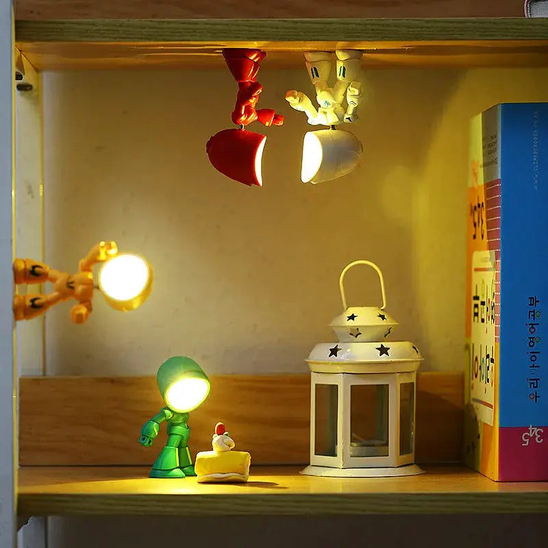 Mini LED night light cartoon hero police desk lamp; green figure lights on a shelf beside a white lantern
