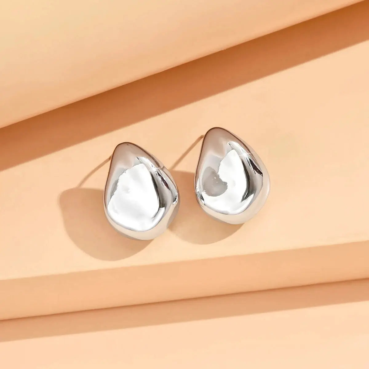 Pair of geometric irregular metal stud earrings, silver-tone teardrop for women, Simples Market