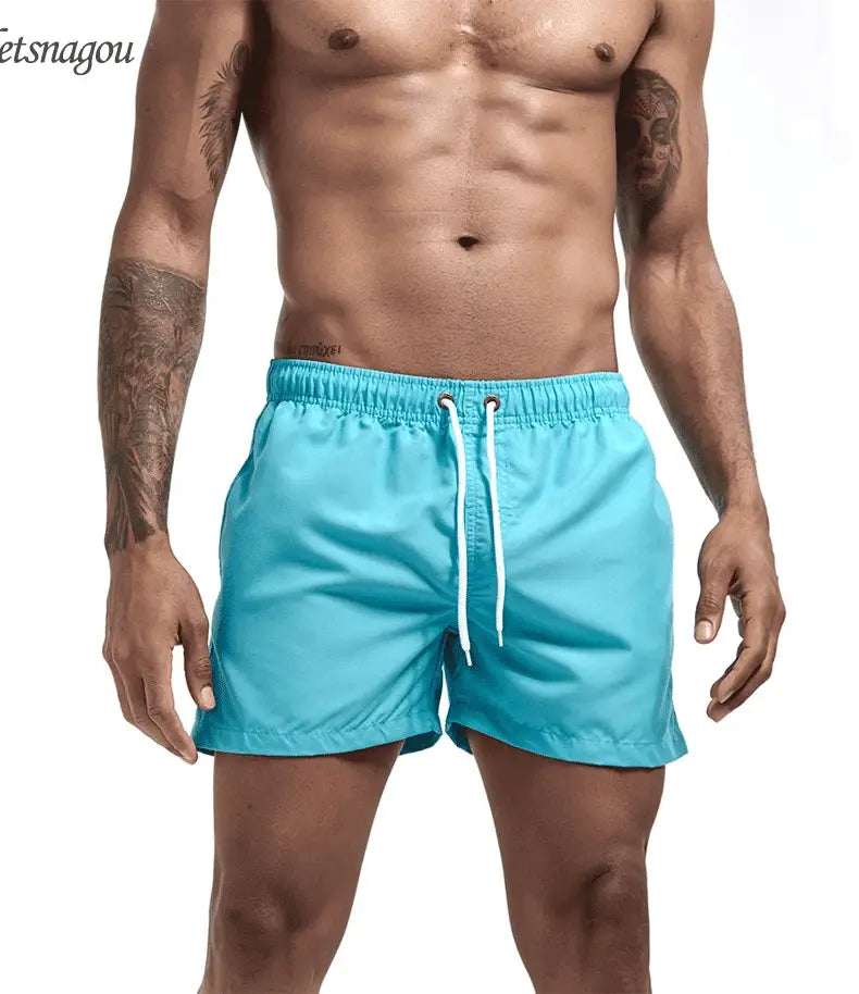 Men's turquoise quick-dry swim trunks with drawstring and pockets