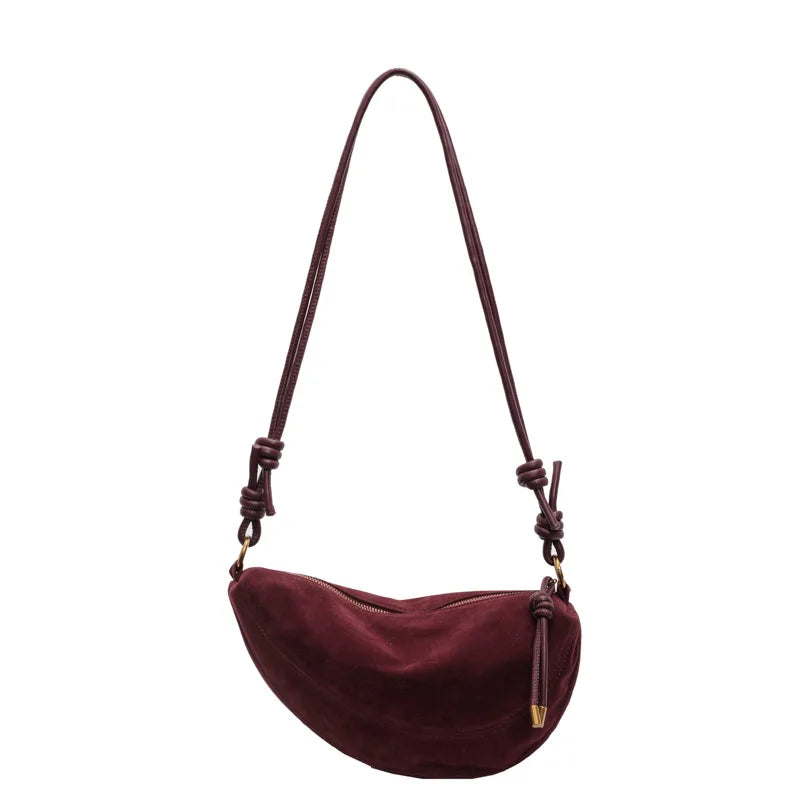 Faux suede crossbody shoulder bag by Simples Market in burgundy with knotted tassel.