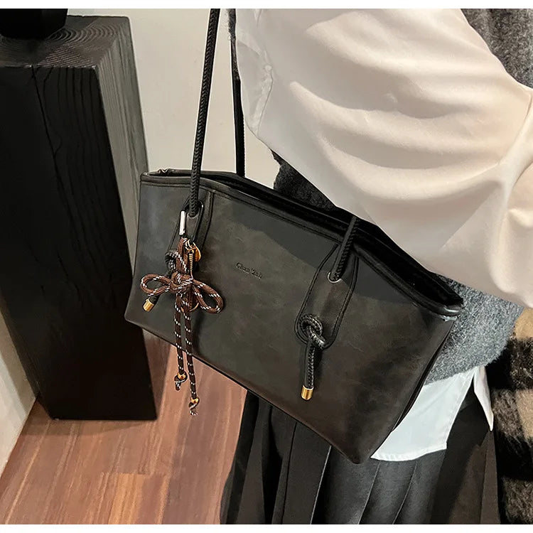 Simples Market black PU leather crossbody shoulder bag with decorative bow charm