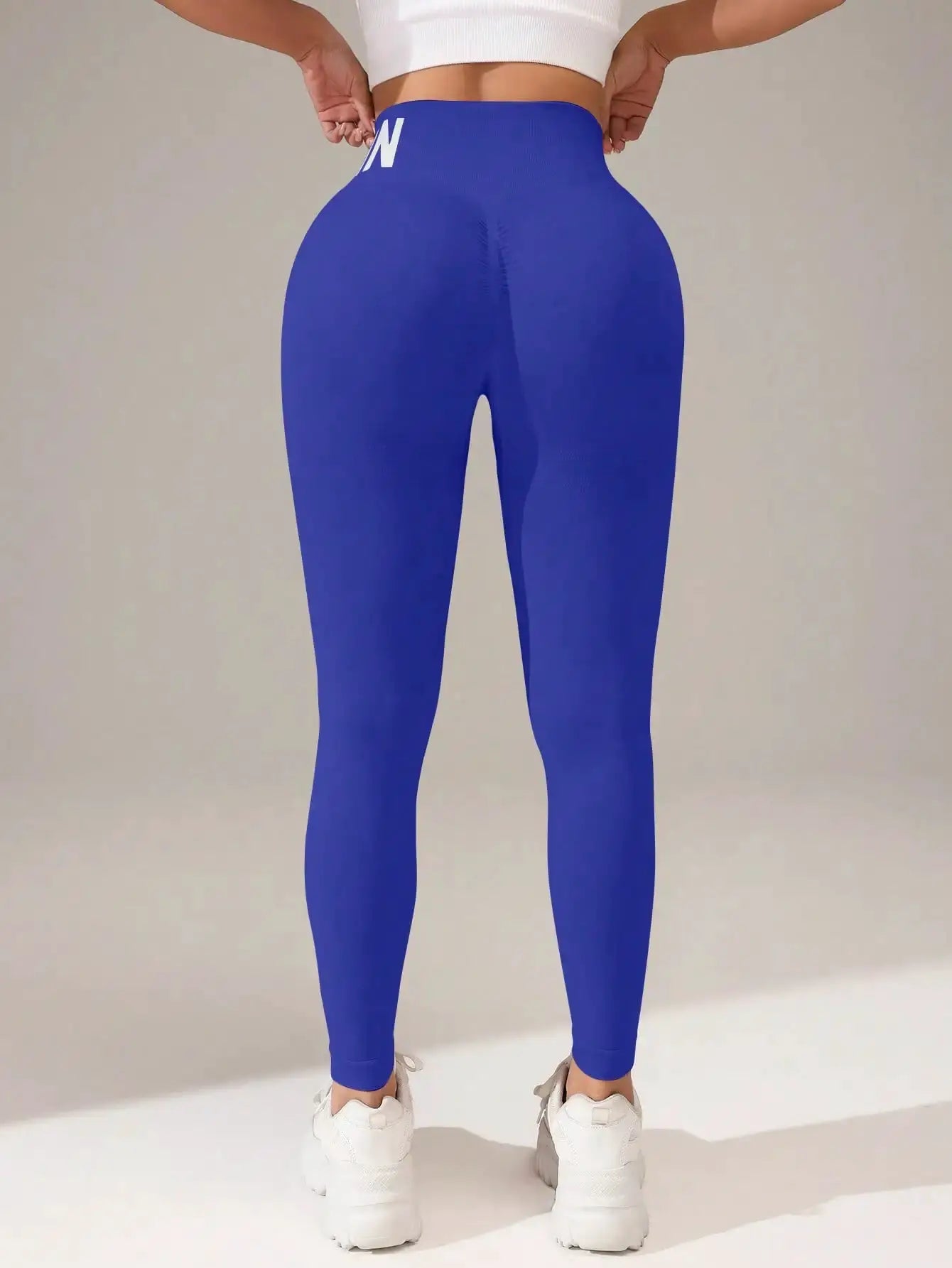 Blue seamless yoga leggings with high waistband and butt-lifting seams, breathable women's tights.