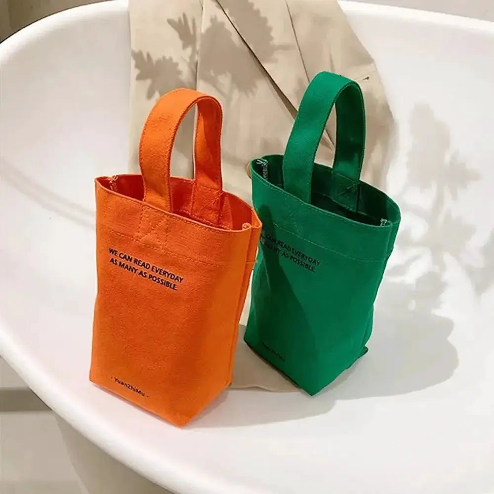 Canvas tote bags in orange and green with short handles; 2-pack casual shopper purses
