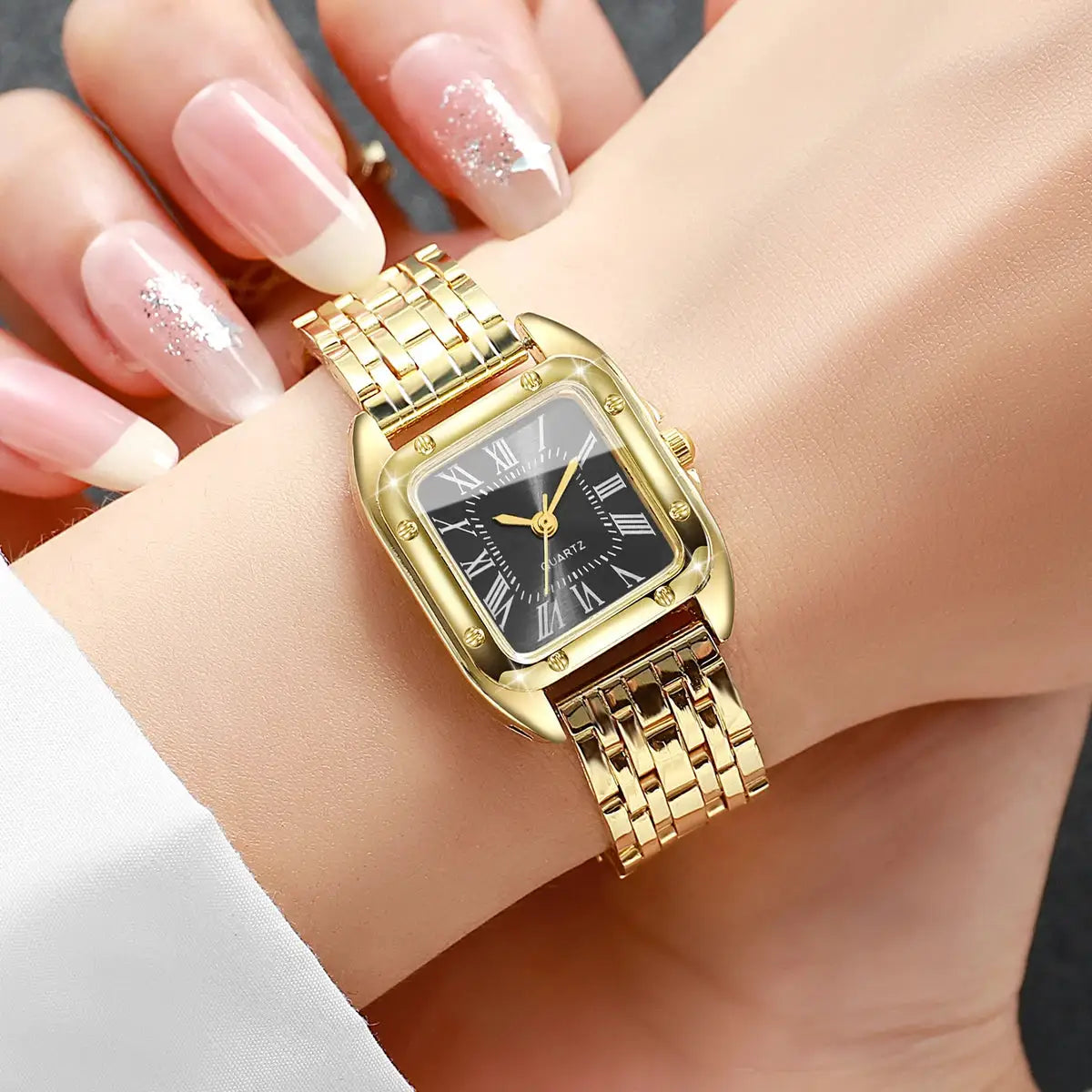 Gold-tone women's square-faced quartz wristwatch with black Roman numeral dial and metal link band