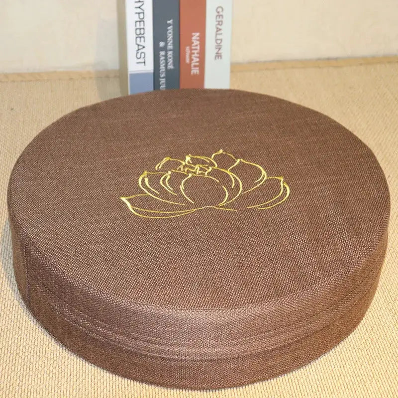 Brown linen yoga meditation cushion, 40x6 cm, round tatami-style with gold lotus embroidery, removable washable cover.