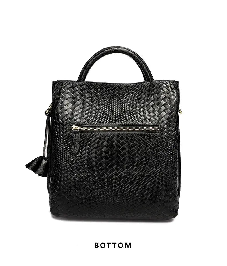 Women's black cowhide woven handbag by Simples Market with top handles and gold zip pocket.